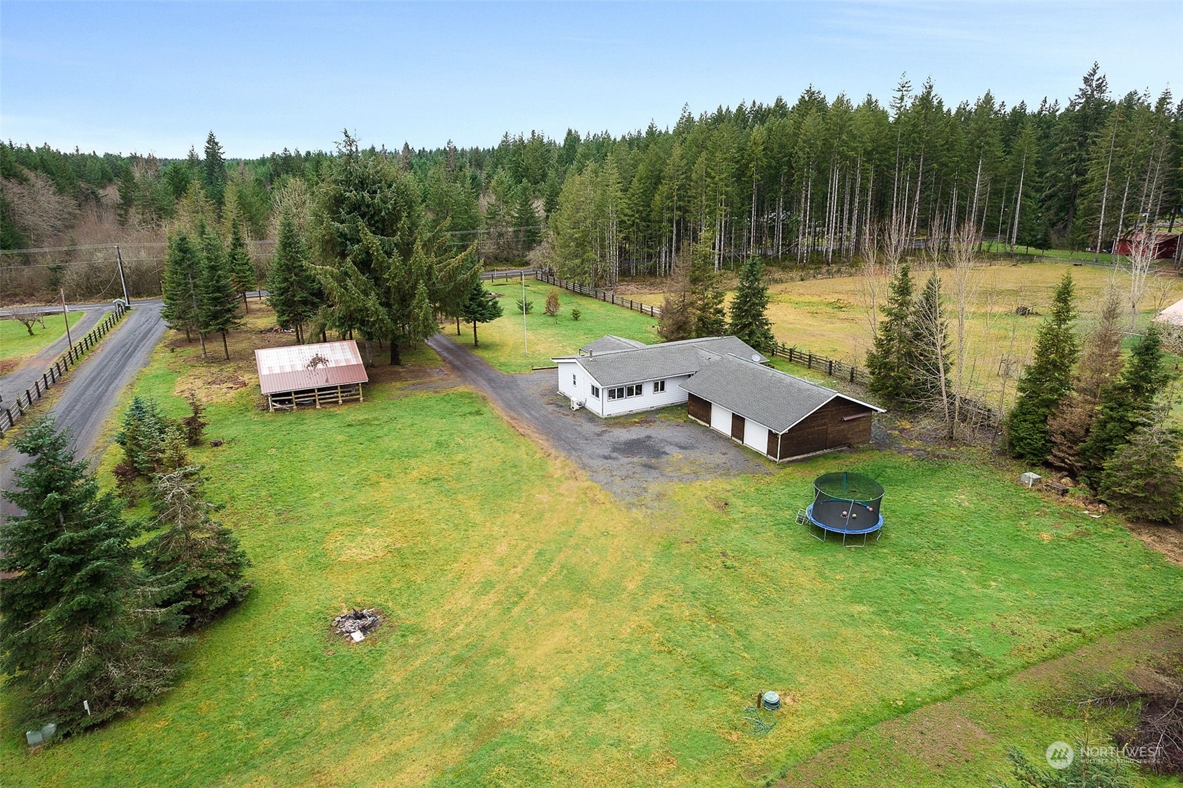 888 Logan Hill Road Chehalis, WA 98532 - Photo 1 of 35 a view of a lake with a yard and trees