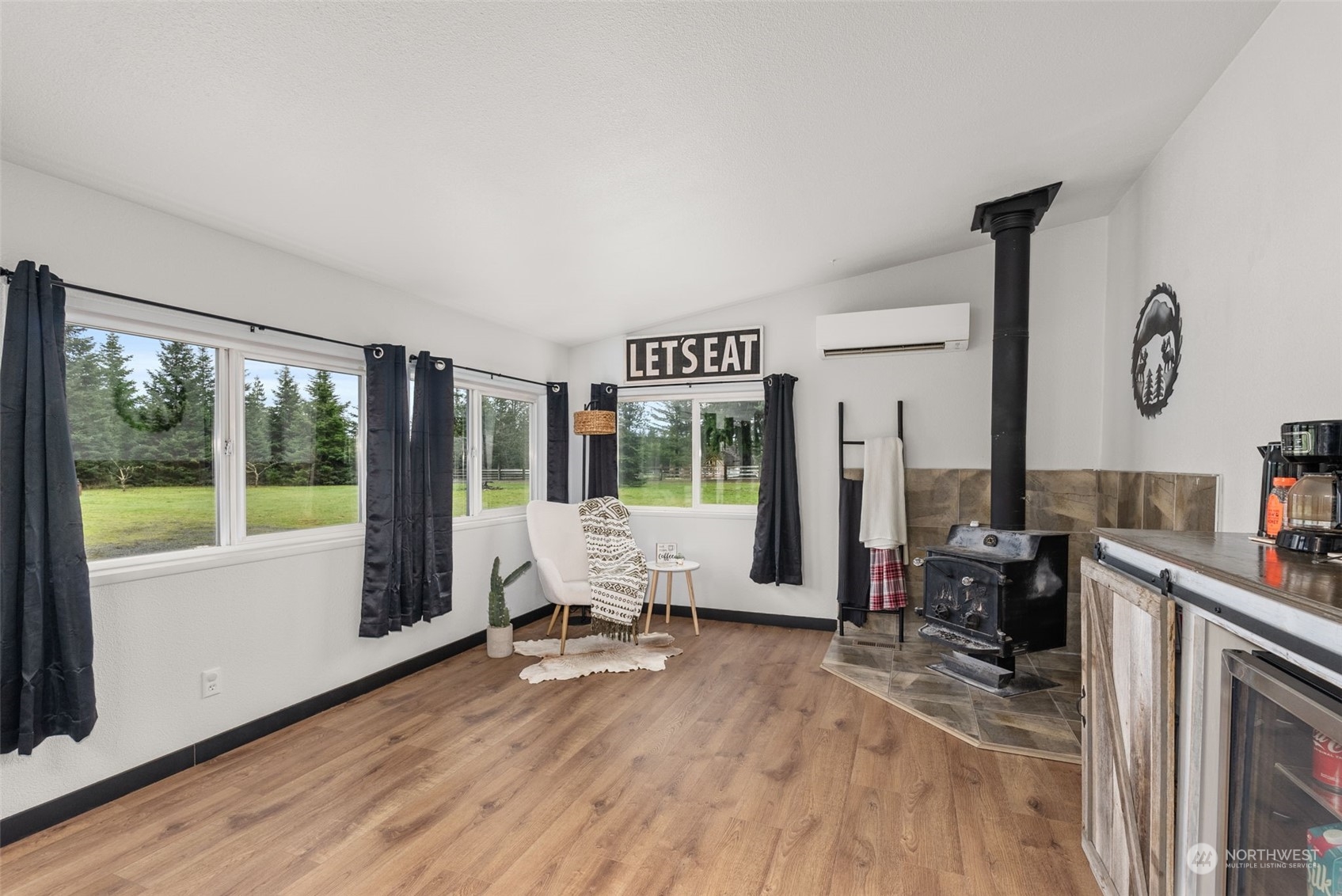 888 Logan Hill Road Chehalis, WA 98532 - Photo 12 of 35 a living room with furniture large windows wooden floor and a rug