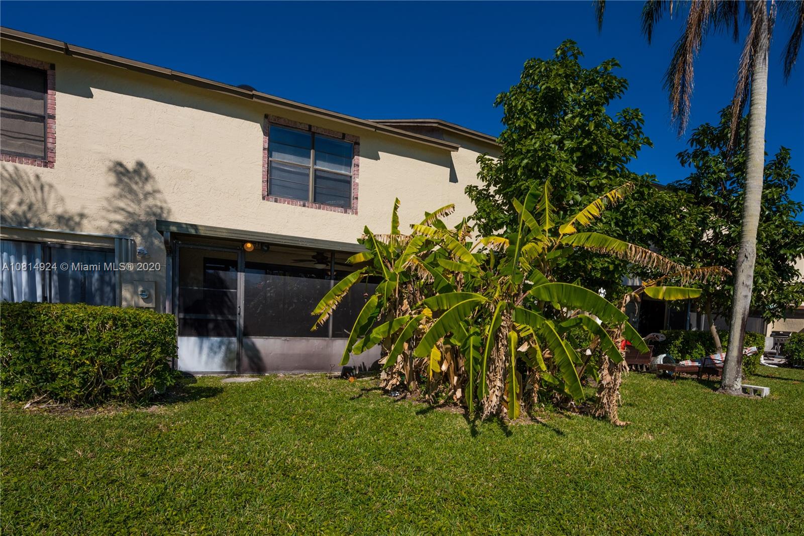 8814 Southwest 22nd Street, Unit B Boca Raton, FL 33433 - Photo 11 of 38 a front view of a house with a garden