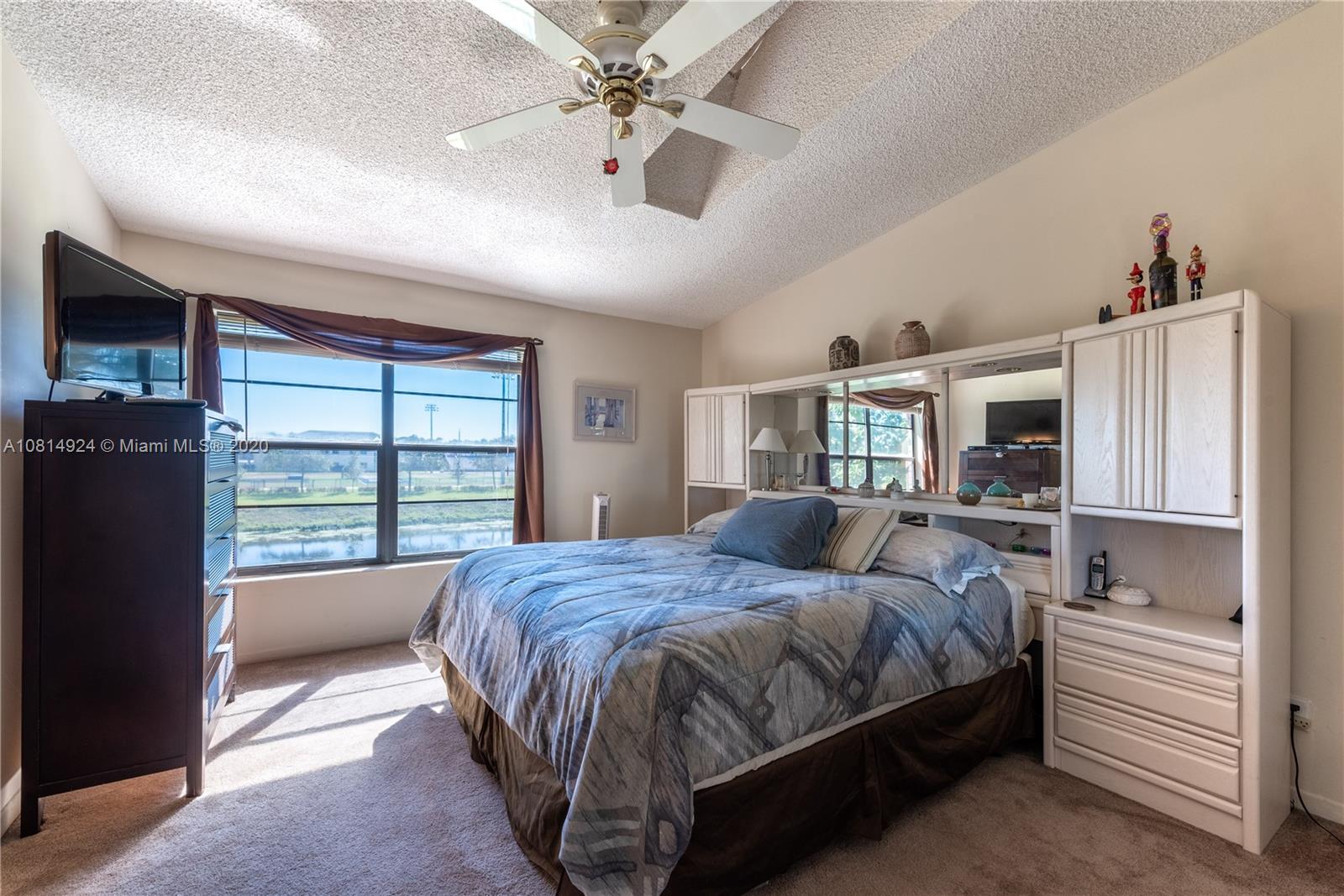 8814 Southwest 22nd Street, Unit B Boca Raton, FL 33433 - Photo 14 of 38 a bedroom with a large bed and a window