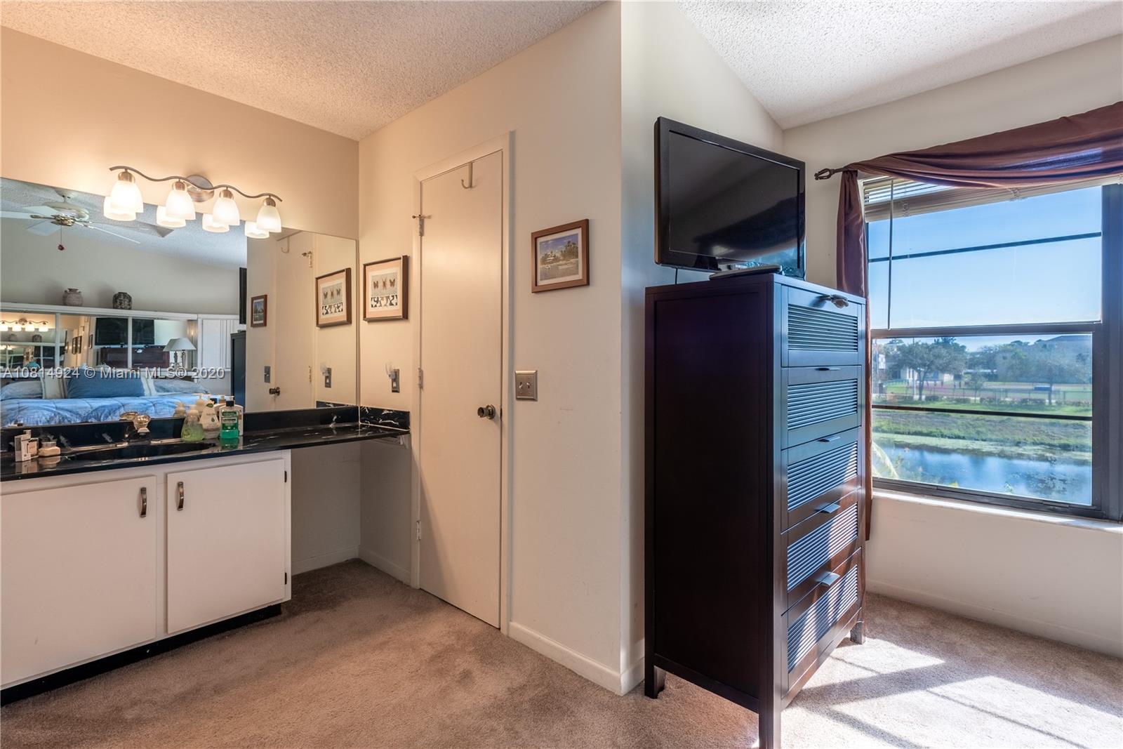 8814 Southwest 22nd Street, Unit B Boca Raton, FL 33433 - Photo 17 of 38 a kitchen with granite countertop a refrigerator and a sink