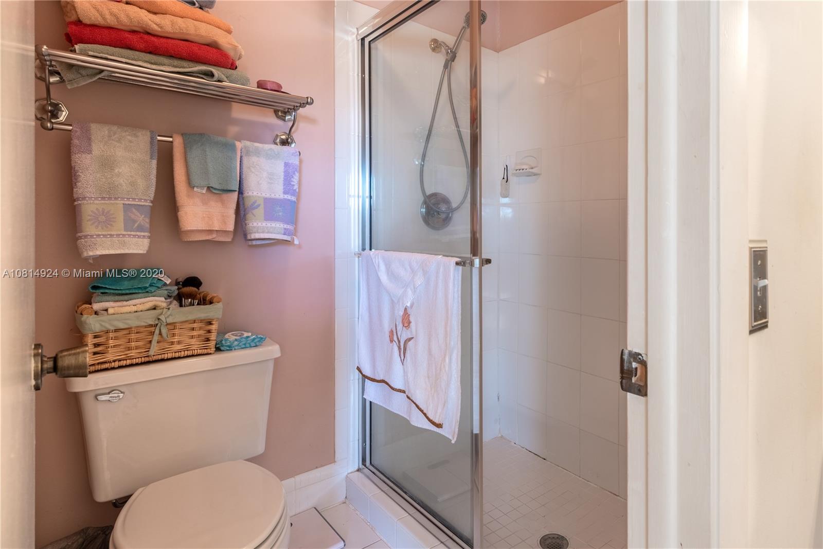 8814 Southwest 22nd Street, Unit B Boca Raton, FL 33433 - Photo 18 of 38 a bathroom with a granite countertop toilet sink and shower