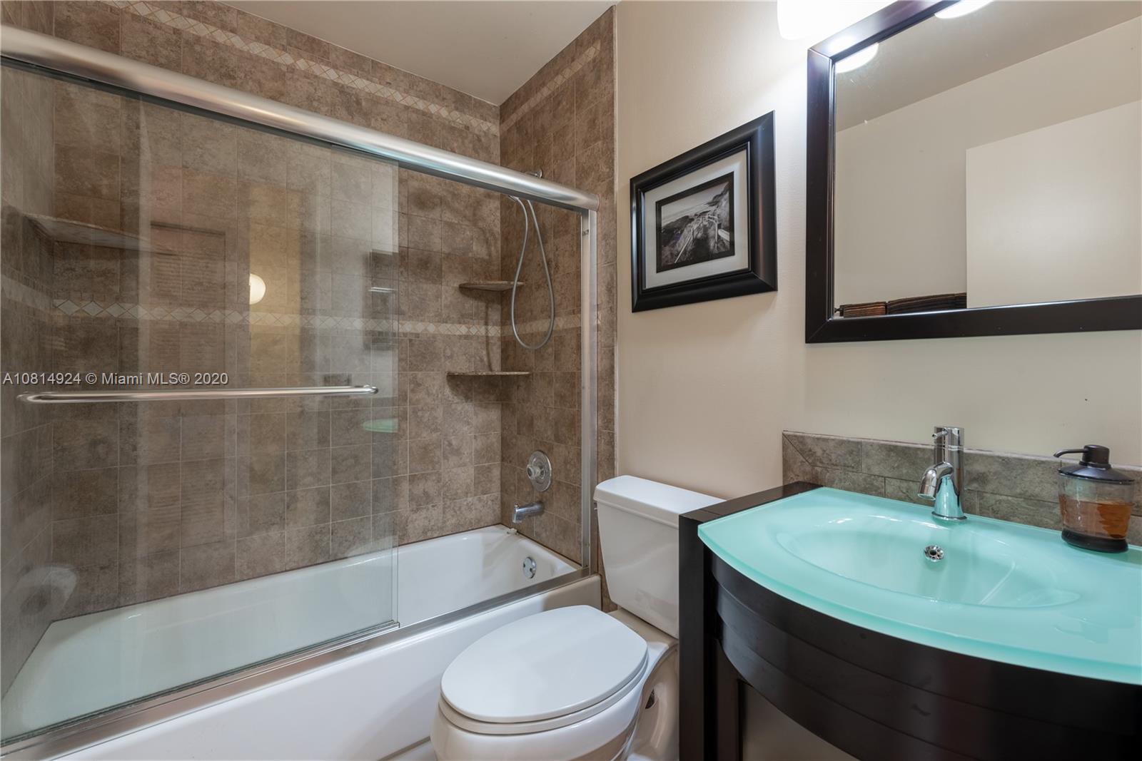 8814 Southwest 22nd Street, Unit B Boca Raton, FL 33433 - Photo 23 of 38 a bathroom with a sink toilet and shower