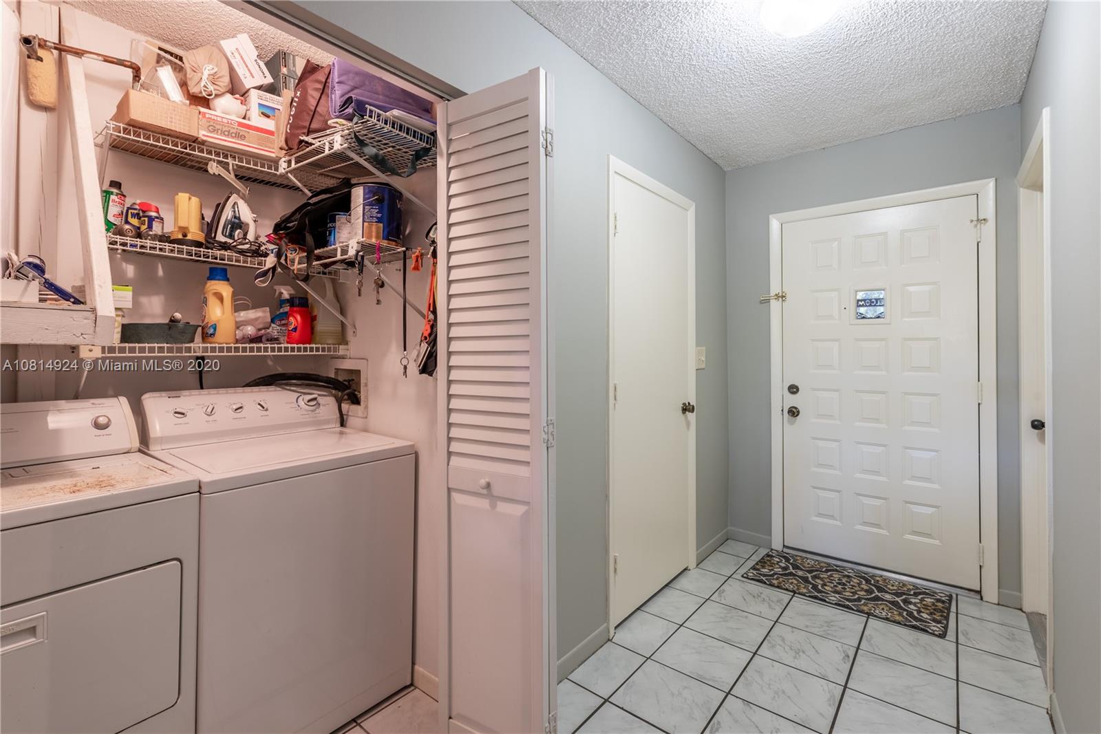 8814 Southwest 22nd Street, Unit B Boca Raton, FL 33433 - Photo 25 of 38 a view of storage and utility room with washer and dryer
