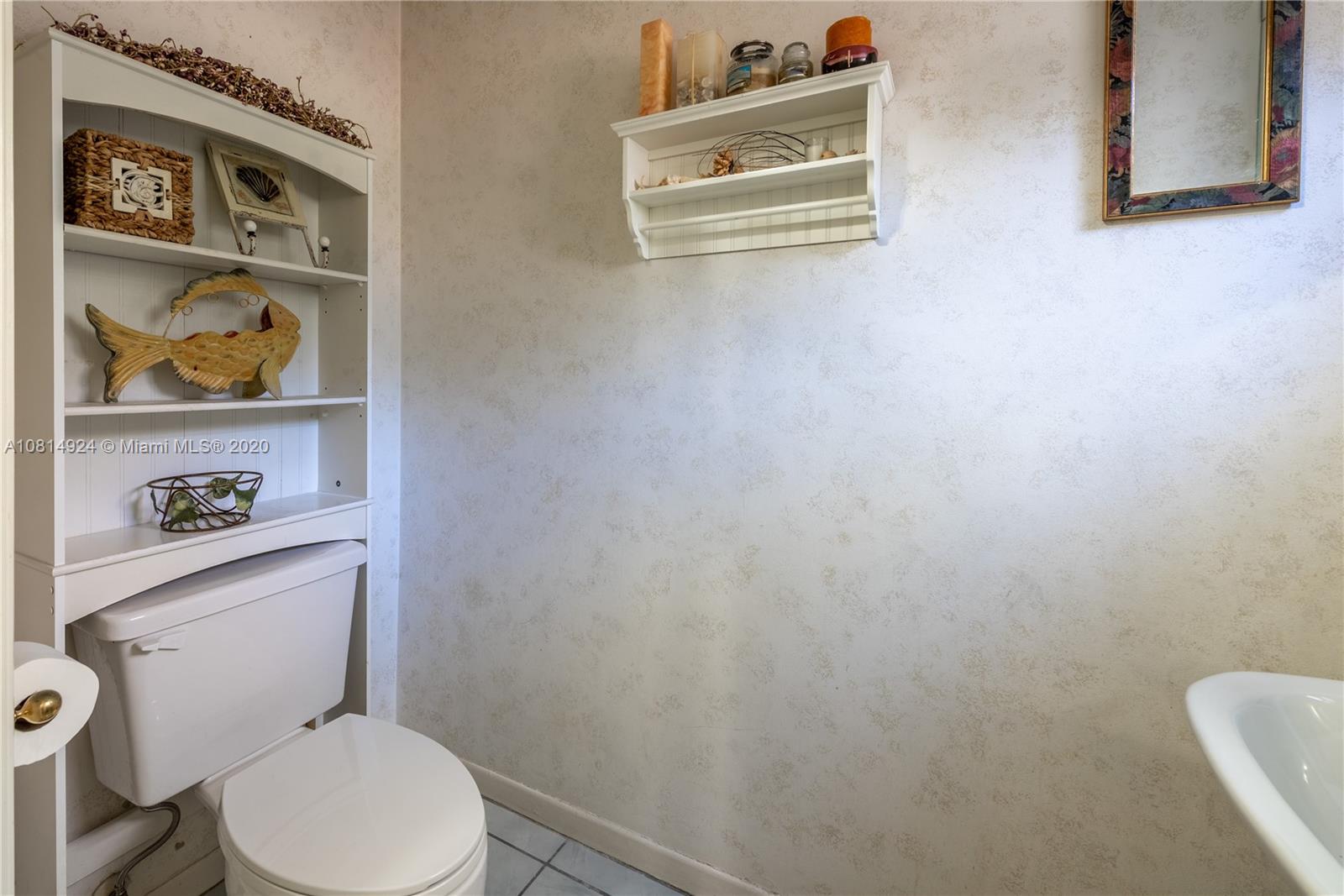 8814 Southwest 22nd Street, Unit B Boca Raton, FL 33433 - Photo 26 of 38 a white toilet sitting next to a bathroom sink