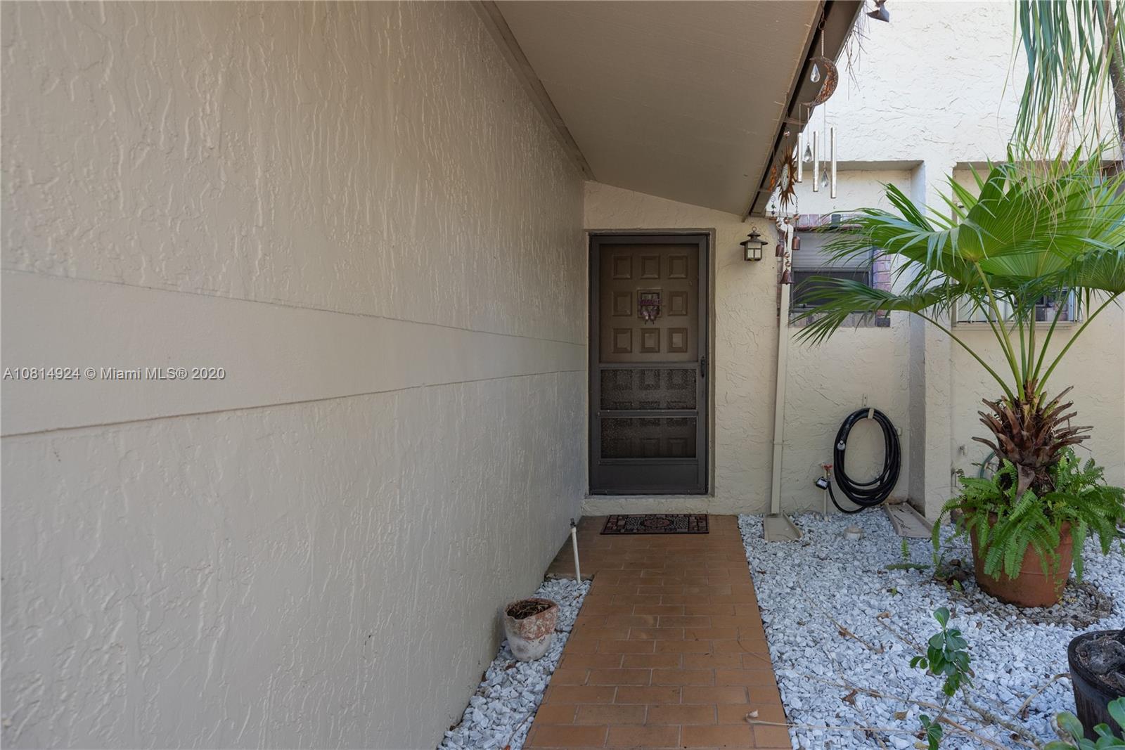 8814 Southwest 22nd Street, Unit B Boca Raton, FL 33433 - Photo 3 of 38 a view of entryway with garden