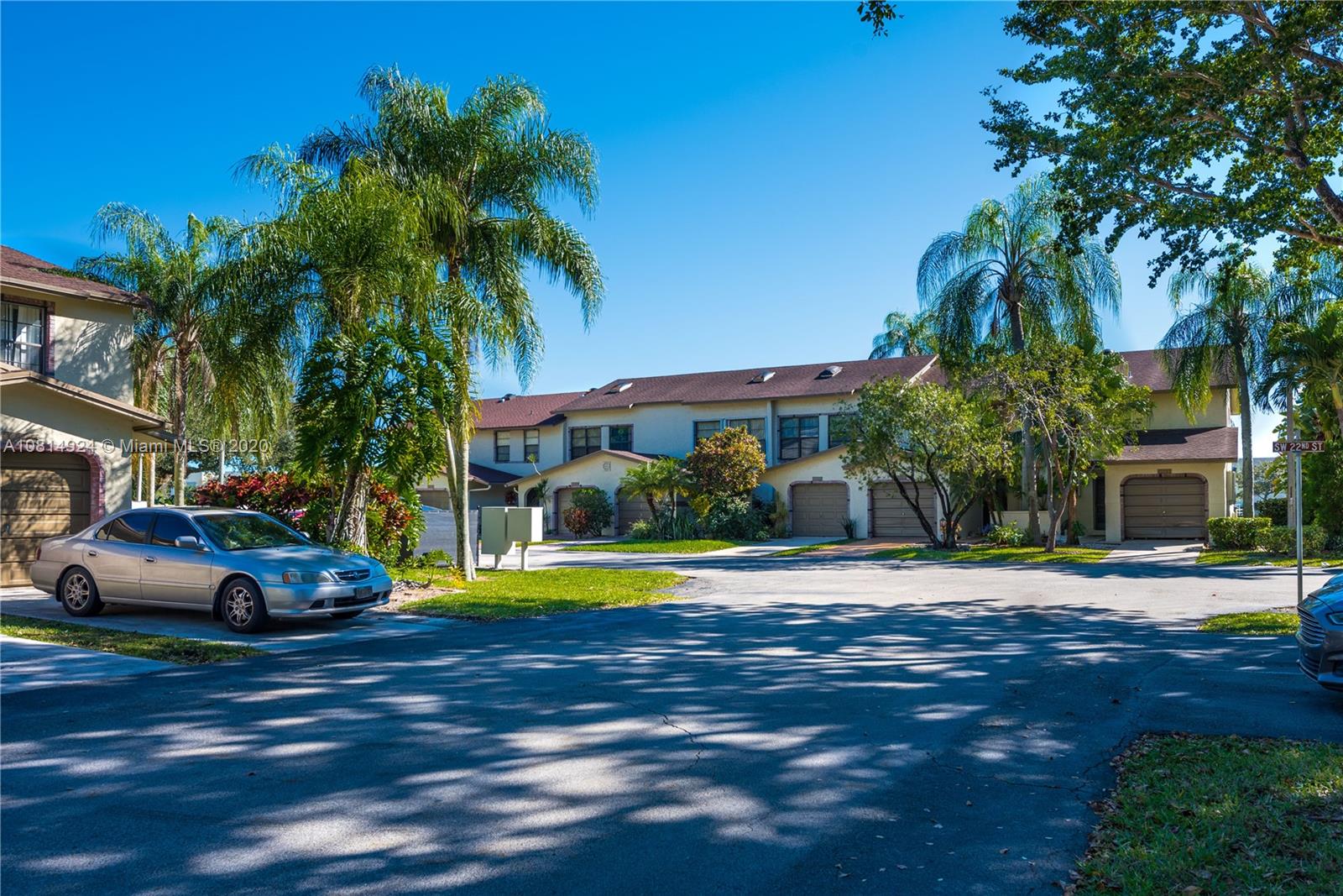 8814 Southwest 22nd Street, Unit B Boca Raton, FL 33433 - Photo 38 of 38 a front view of a house with a yard and palm trees