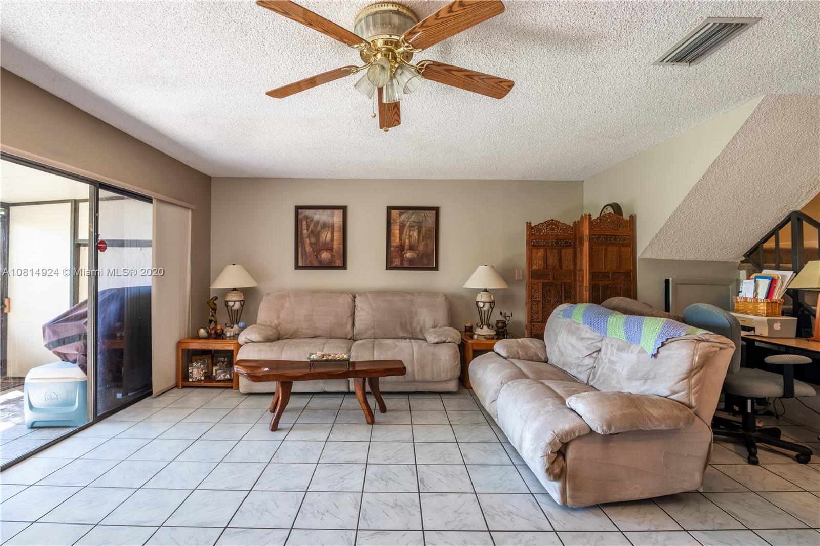 8814 Southwest 22nd Street, Unit B Boca Raton, FL 33433 - Photo 7 of 38 a living room with furniture and a table