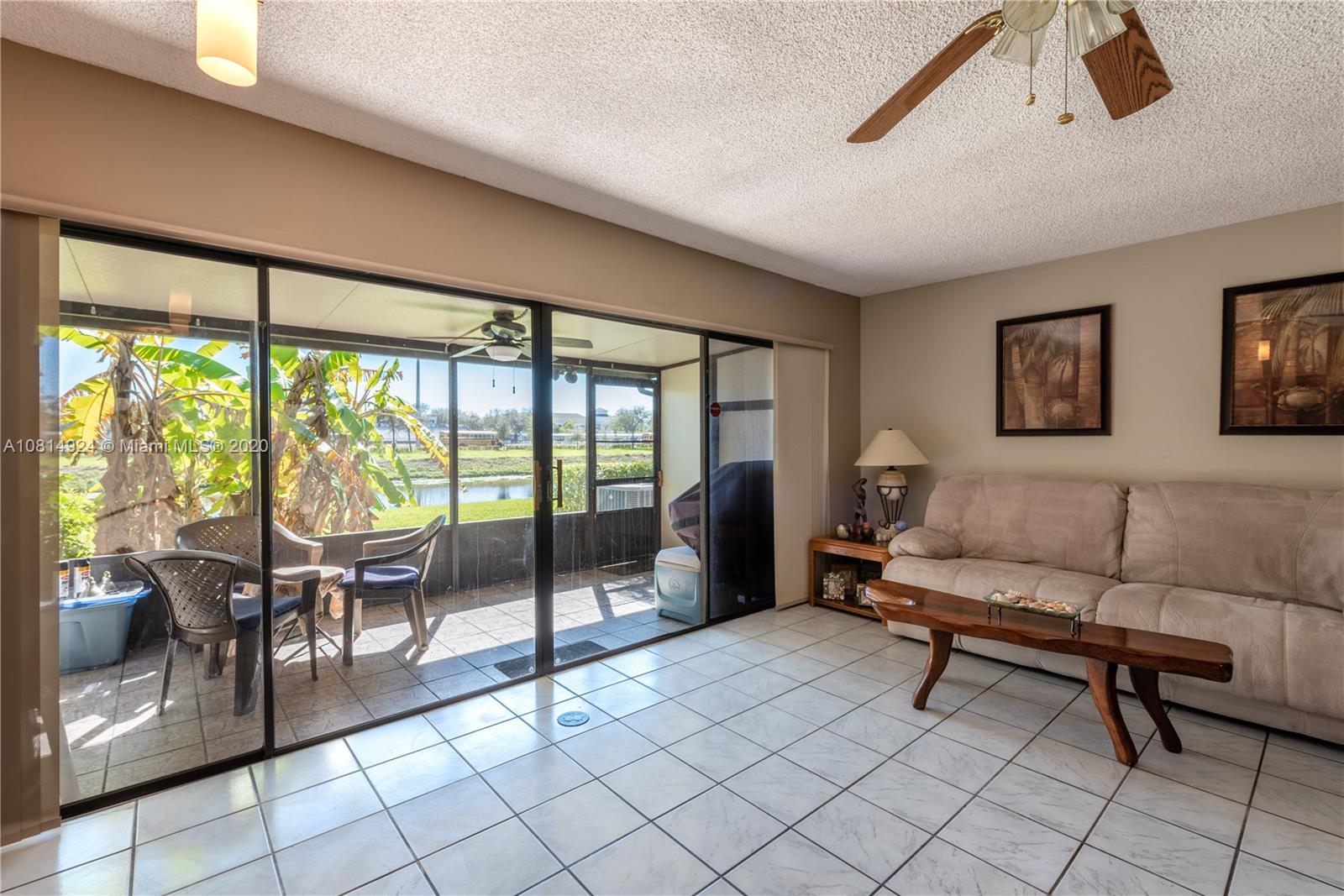 8814 Southwest 22nd Street, Unit B Boca Raton, FL 33433 - Photo 8 of 38 a living room with furniture and a floor to ceiling window