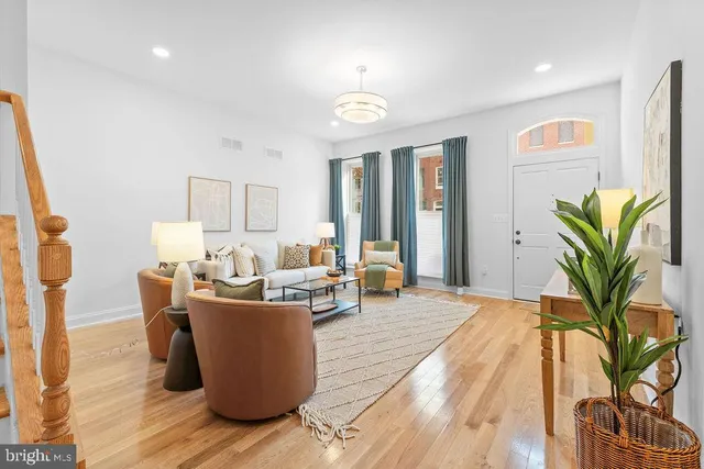 a living room with furniture and a potted plant