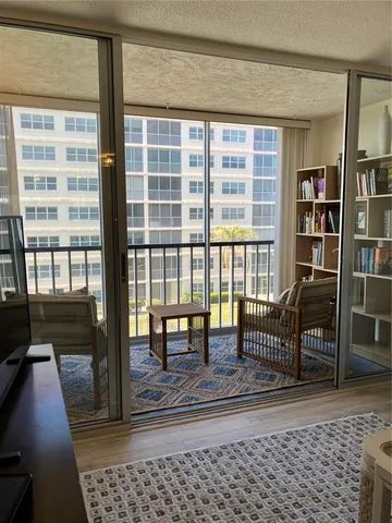 a living room with furniture and a floor to ceiling window