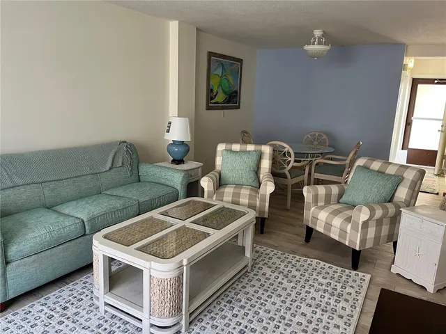 a living room with a couch and a stove next to a window