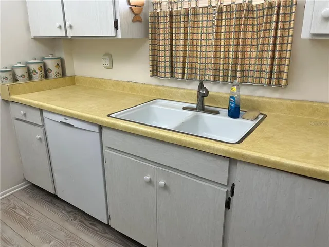 a room with a sink and cabinets