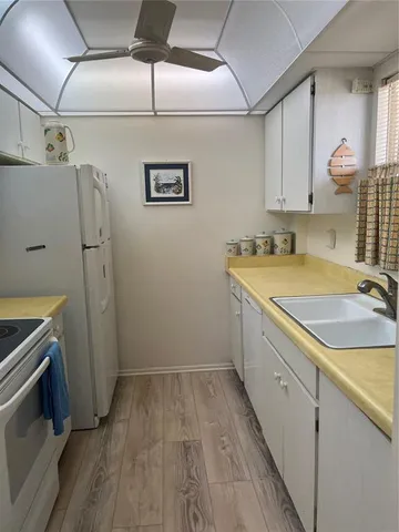 a room with a sink and a refrigerator