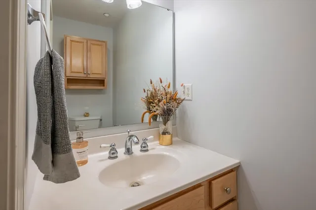 a bathroom with a sink vanity and a mirror