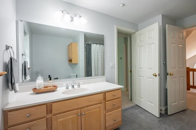a bathroom with a double vanity sink and a mirror