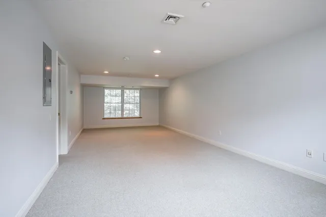 a view of an empty room and a window