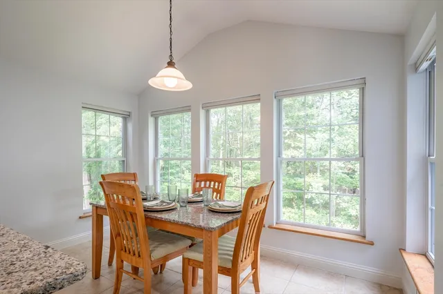 a dining room with furniture window and outside view
