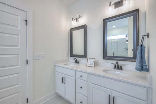 a bathroom with 2 sink and a mirror