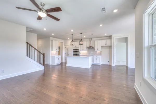 a view of kitchen with kitchen island and stainless steel appliances