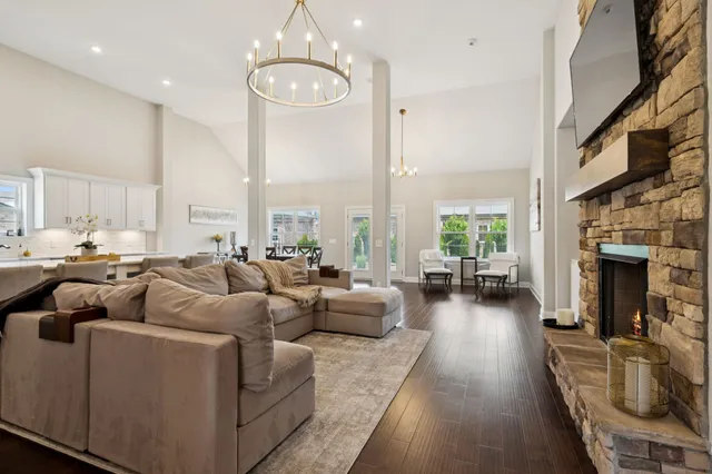 a living room with furniture fireplace and a large window
