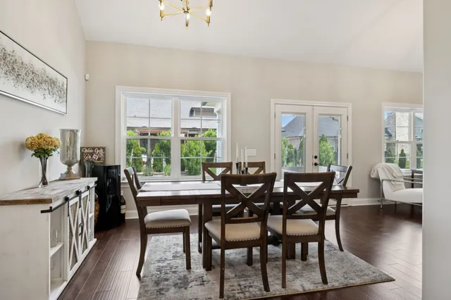 a dining room with furniture and wooden floor