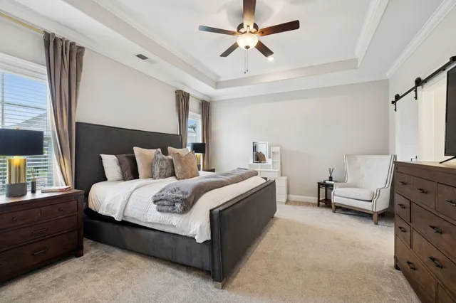 a spacious bedroom with a bed and a chandelier