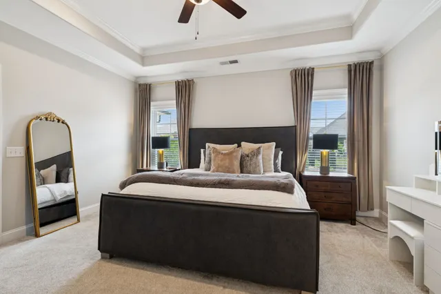 a bed sitting in a bedroom next to a window