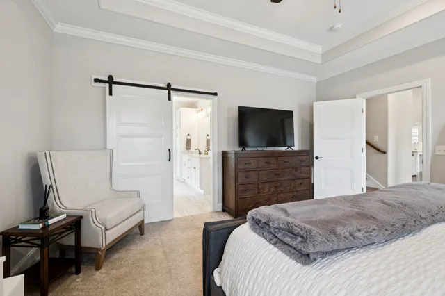 a bedroom with a bed and a television