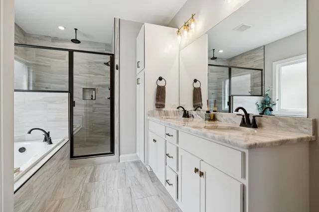 a bathroom with a double vanity sink a mirror and shower