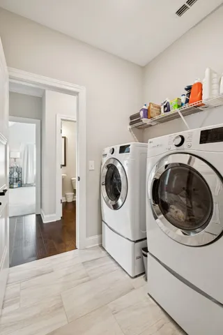 a utility room with sink dryer and washer