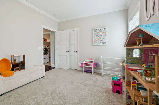 a living room with furniture and a book shelf