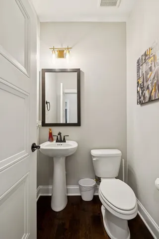 a white toilet sitting next to a bathroom sink