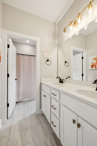 a spacious bathroom with a double vanity sink mirror and shower