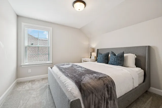 a bedroom with bed and window