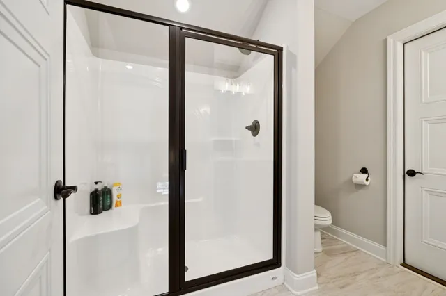 a bathroom with a glass shower door