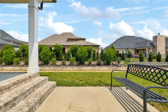 a view of a patio with a table chairs and a yard