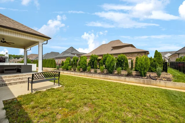 a view of a patio with a table and chairs under an umbrella