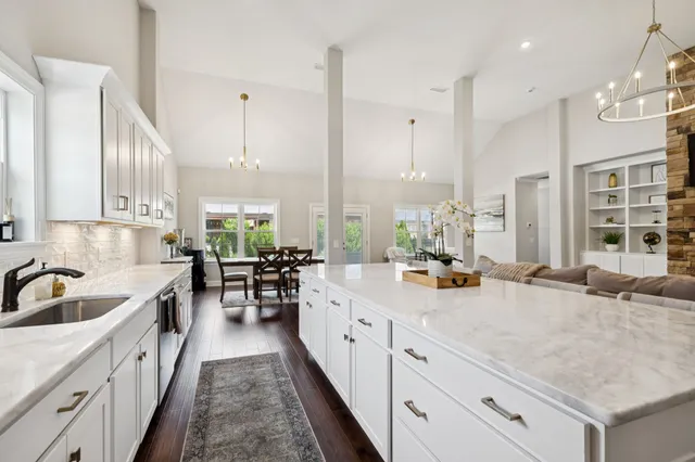 a kitchen with counter top space a sink stainless steel appliances and cabinets