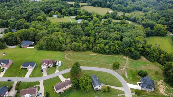 an aerial view of a golf course with chairs