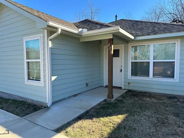 a view of a house with a small yard