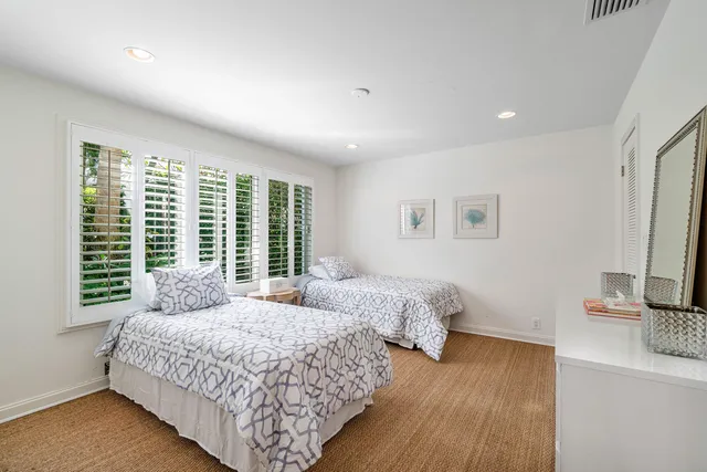 a bedroom with two beds and a flat screen tv