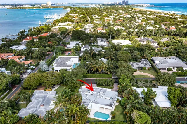 an aerial view of residential houses with outdoor space and swimming pool