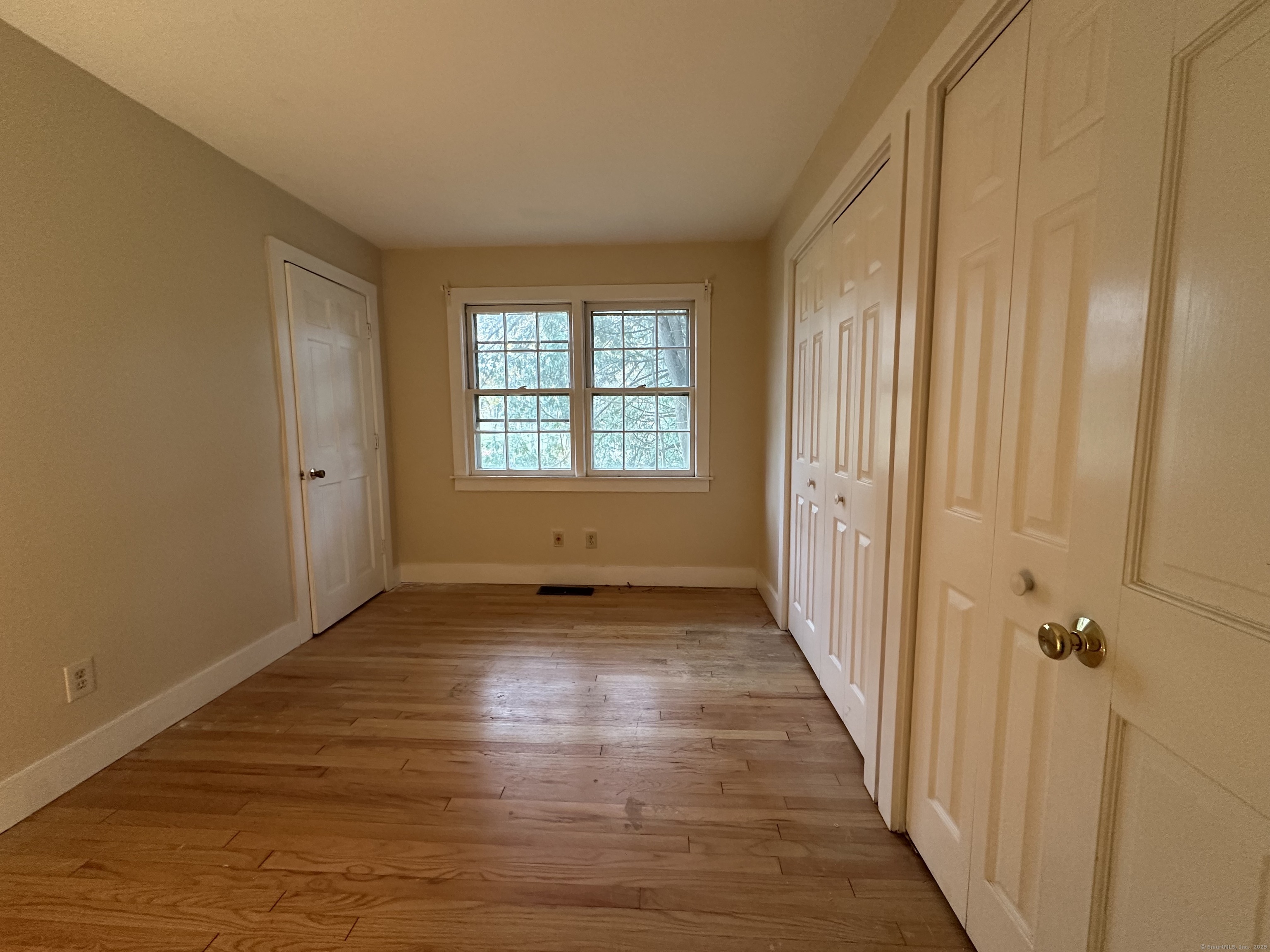 25 Elephant Rock Road, Unit 2 Woodbury, CT 06798 - Photo 12 of 17 a view of a hallway with wooden floor and a bathroom