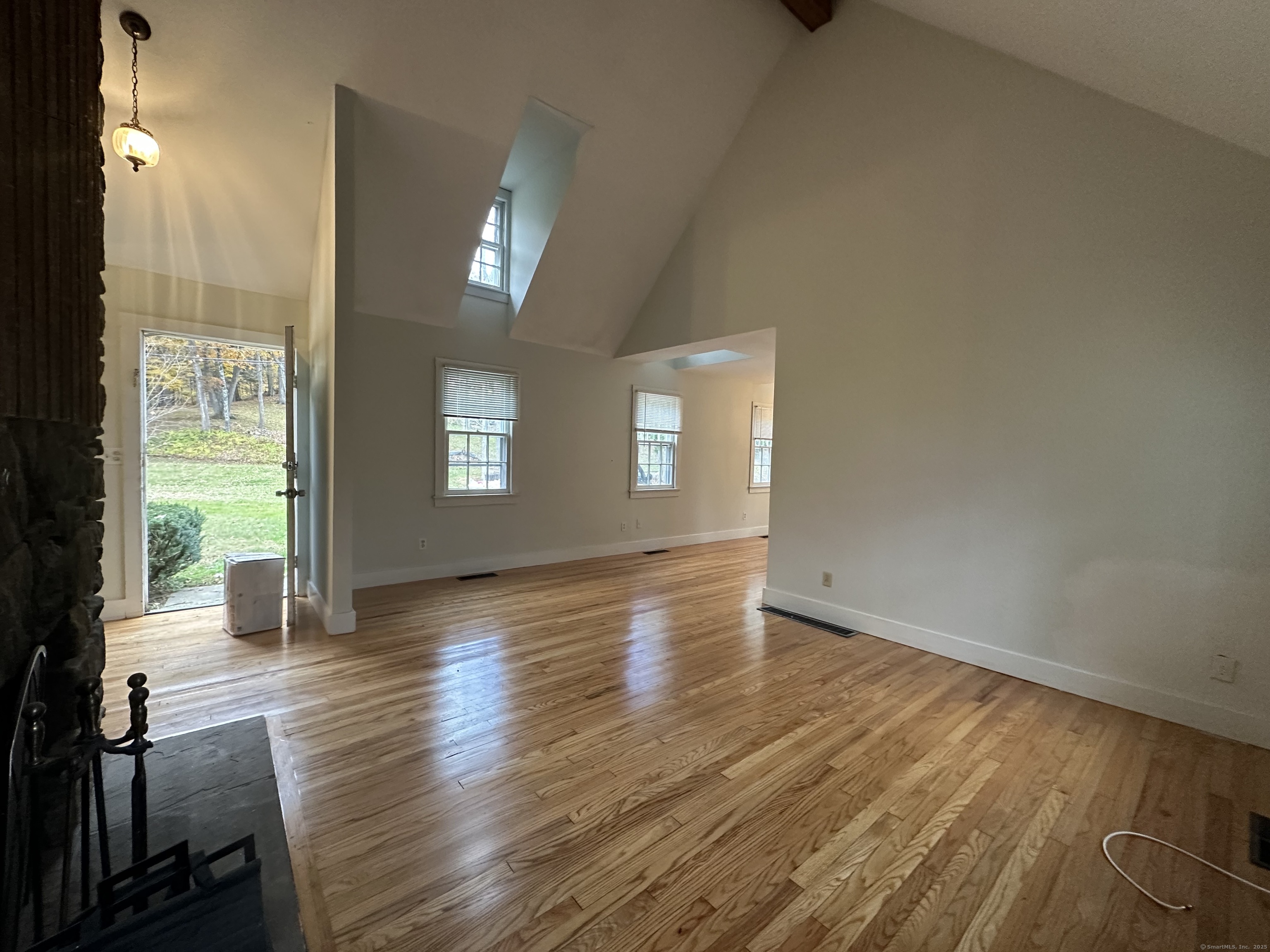 25 Elephant Rock Road, Unit 2 Woodbury, CT 06798 - Photo 5 of 17 an empty room with wooden floor and windows