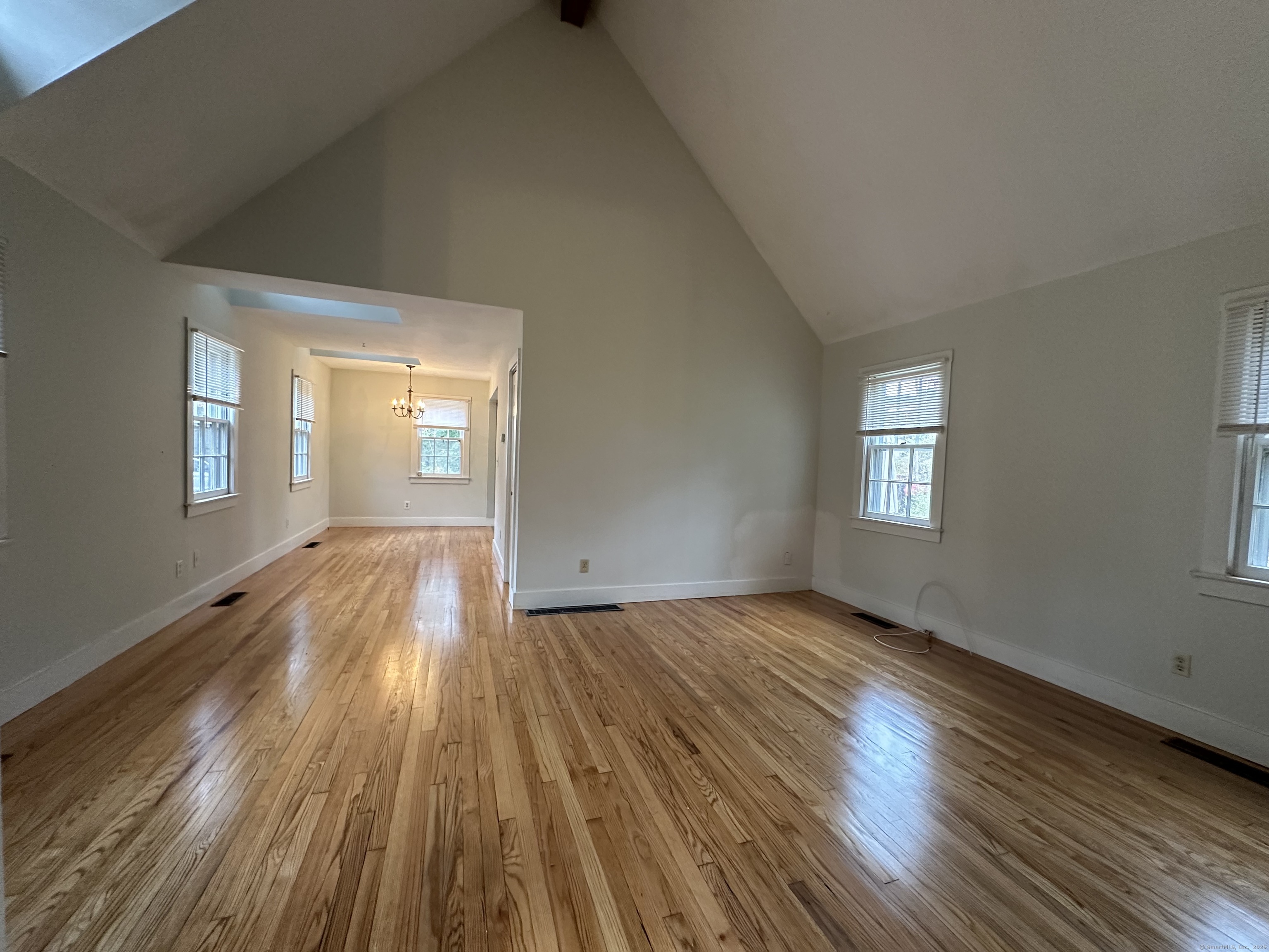 25 Elephant Rock Road, Unit 2 Woodbury, CT 06798 - Photo 6 of 17 a view of an empty room with wooden floor and a window