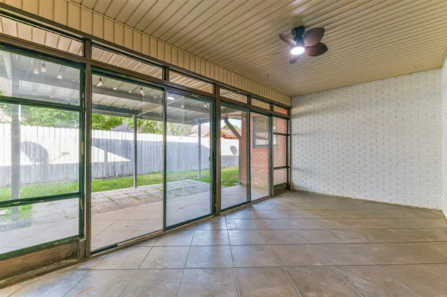 a view of an empty room with a fireplace and a large window
