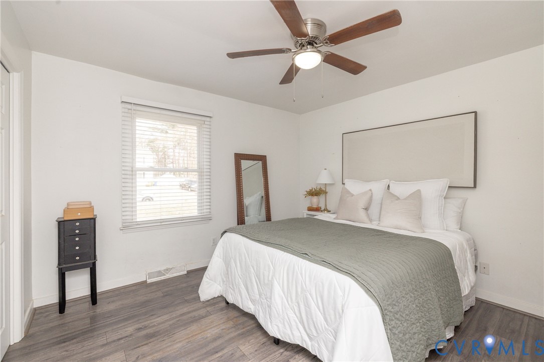 16104 Sandwave Road Chester, VA 23831 - Photo 13 of 24 a bedroom with a large bed and a chandelier