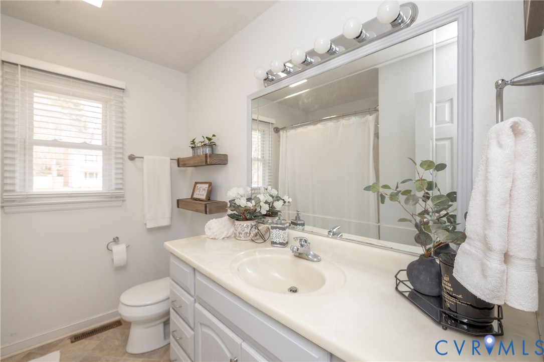 16104 Sandwave Road Chester, VA 23831 - Photo 15 of 24 a bathroom with a sink toilet and shower