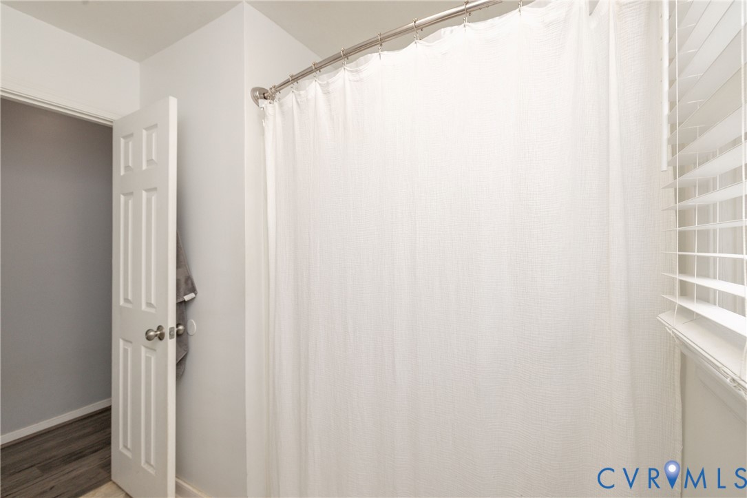 16104 Sandwave Road Chester, VA 23831 - Photo 17 of 24 a bathroom with a shower curtain